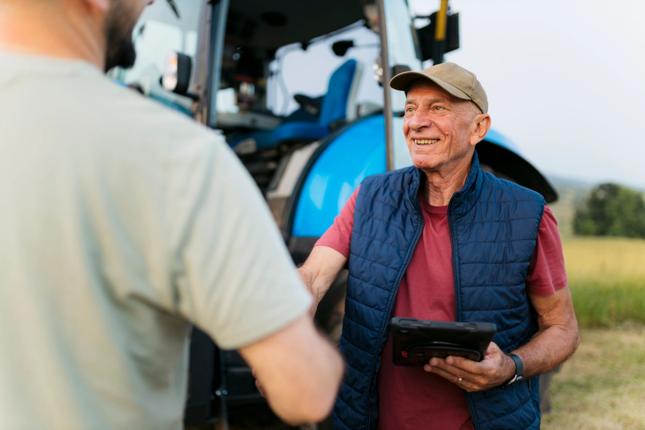 Team member assisting a farmer with tractor selection